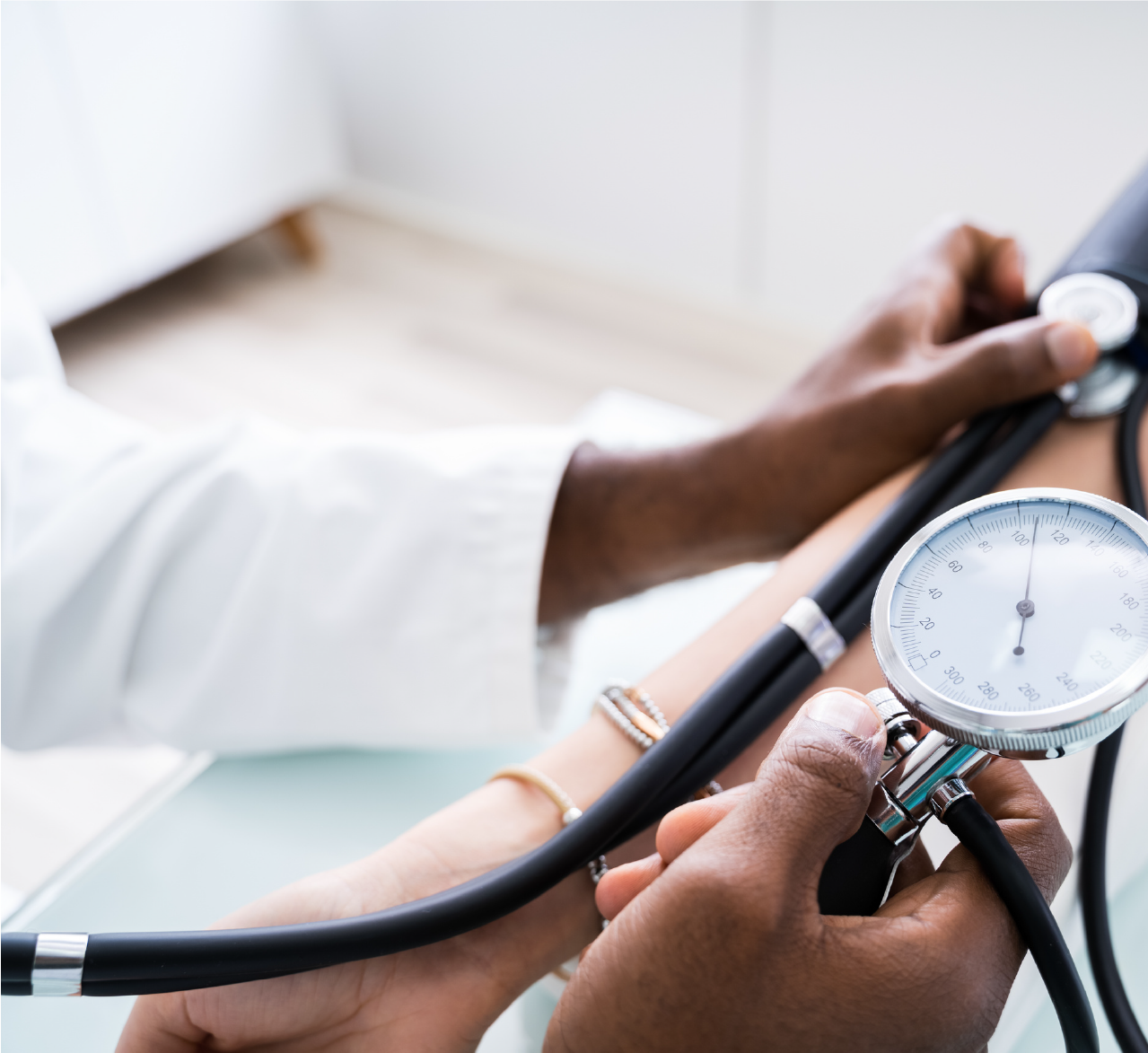Healthcare professional measuring blood pressure with a sphygmomanometer.