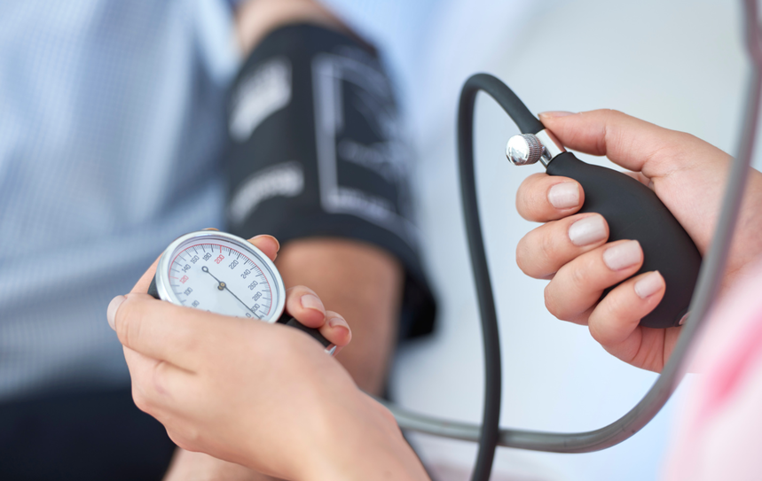Professional blood pressure screening for a patient during a hypertension check.