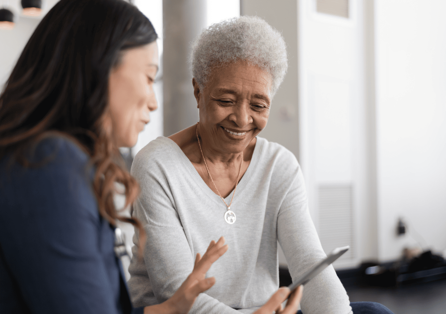 Smiling senior woman consulting with a healthcare provider during a same-day appointment at Optima Medical clinic in Arizona.