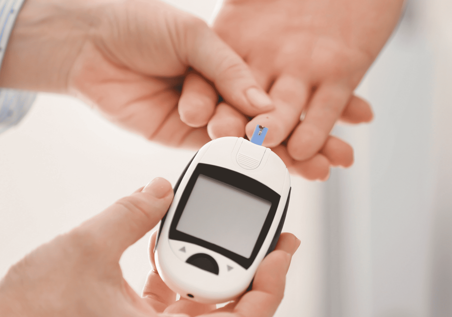 Healthcare provider checking blood sugar levels with a glucose meter as part of Optima Medical’s diabetes management program in Arizona.