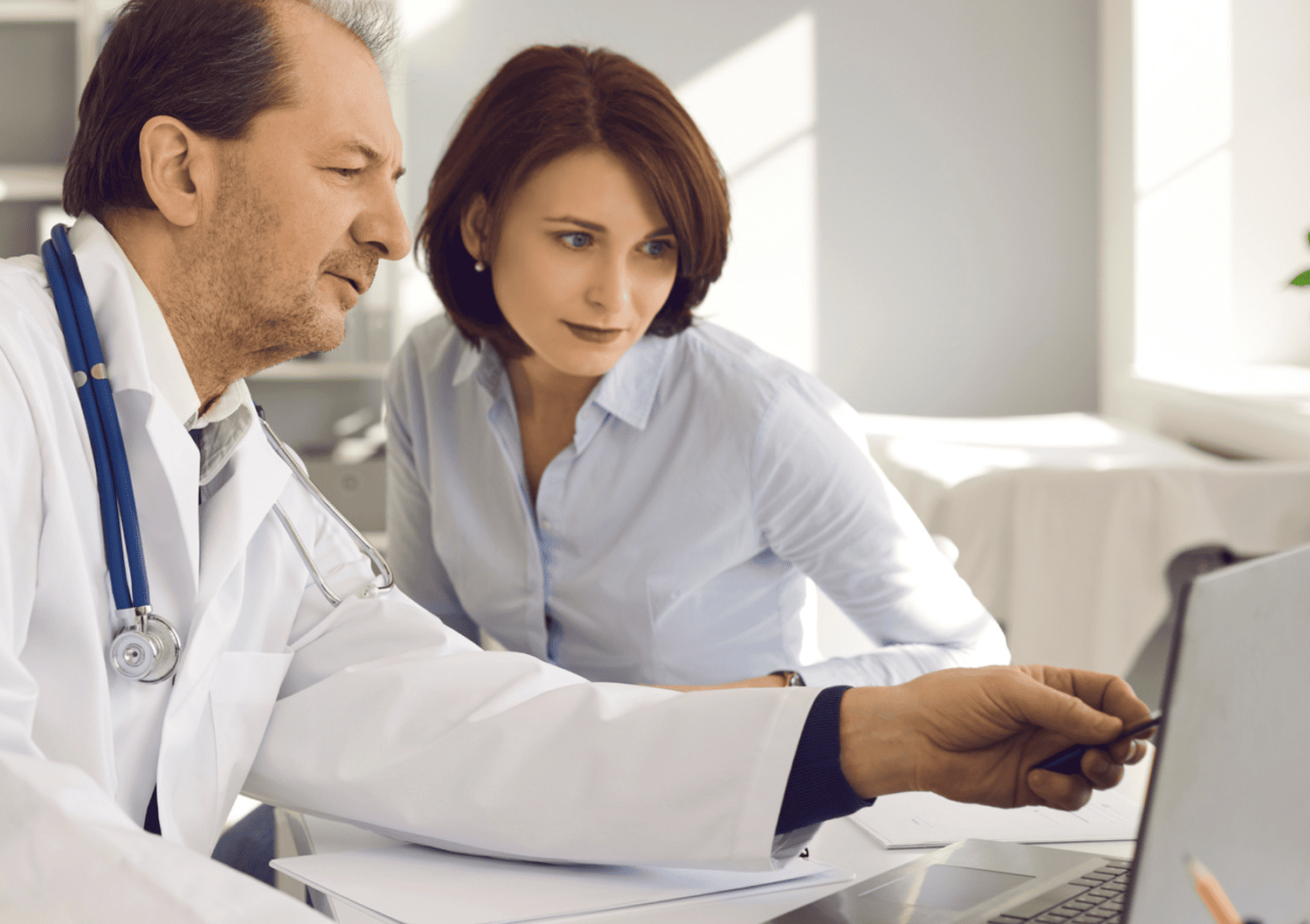 Doctor discussing cancer screening results with a patient at Optima Medical clinic in Arizona.