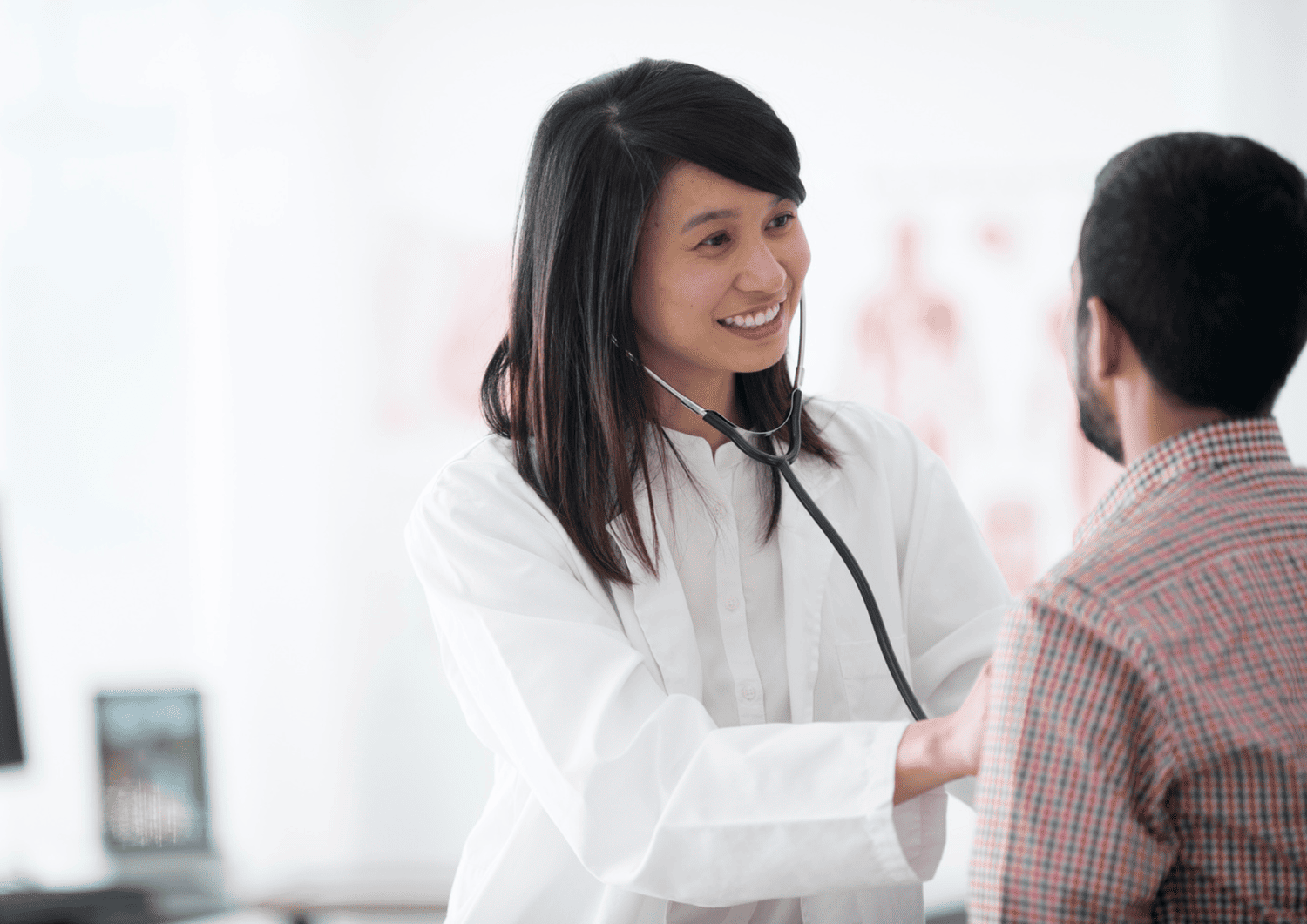 Doctor performing an annual wellness check-up and discussing preventive healthcare with a patient at Optima Medical clinic.