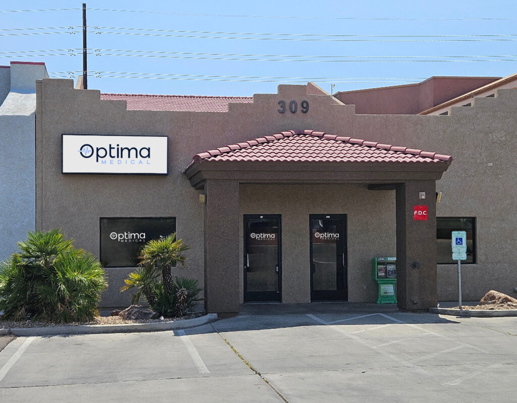 Exterior view of Optima Medical primary care clinic at 309 Lake Havasu Avenue in Lake Havasu City, Arizona, featuring tan stucco building with red tile roof and Optima Medical signage.